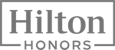 The image displays the logo of "Hilton Honors," featuring the text inside a rectangular border with "Hilton" above "Honors" in bold font.