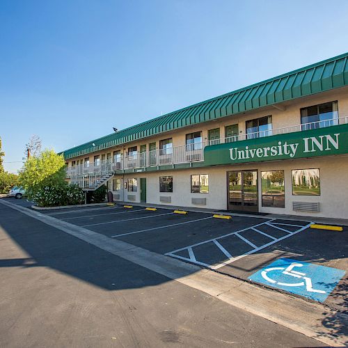 A two-story building with a green sign that reads 